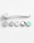 White electric body cleansing brush with long handle and five interchangeable attachment heads