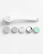 White electric body cleansing brush with long handle and five interchangeable attachment heads