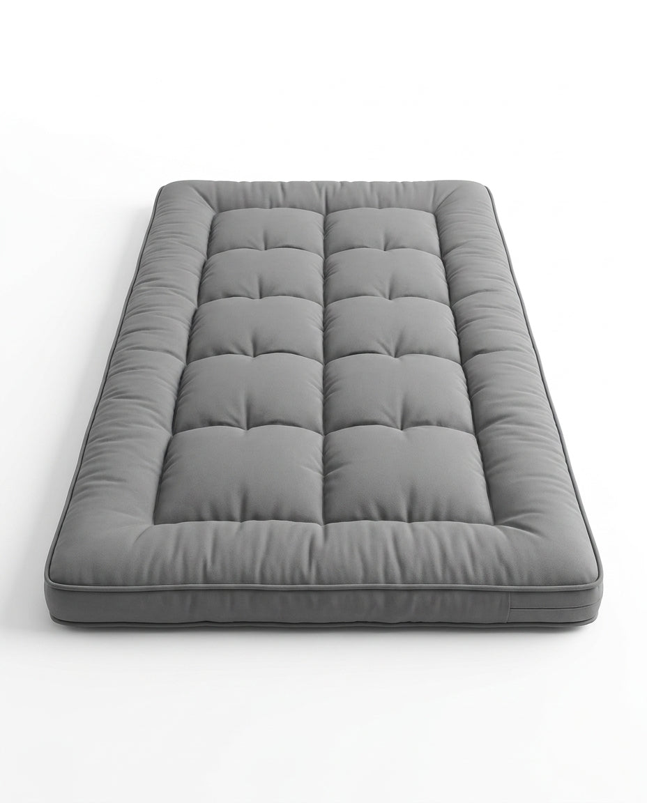Grey quilted foldable floor comfort mattress, studio shot on white