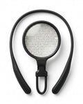 Black hands-free neck magnifier with round lens over a page of text, top-down