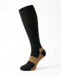Black knee-high compression sock with copper heel and arch, studio on white