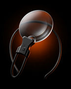 Hands-free neck magnifier lens on a dark studio backdrop with amber glow