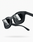 Black prism bed reading glasses with angled mirror lenses, studio shot on white