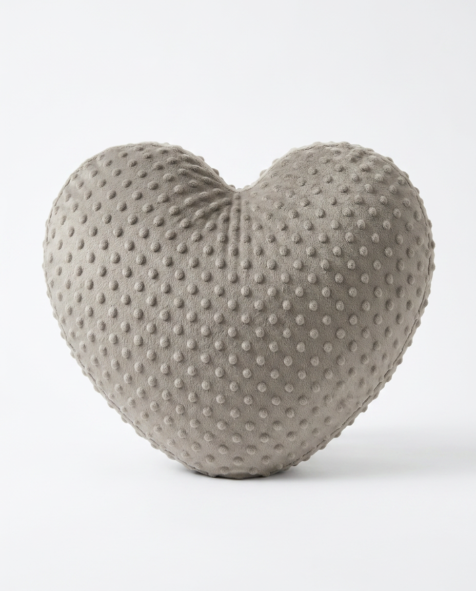 Grey heart-shaped weighted comfort cushion with minky dot texture on white