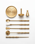 Brass incense ritual tool kit with lotus tray, cone press and tools on white