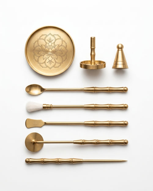Brass incense ritual tool kit with lotus tray, cone press and tools on white