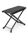 Black folding footrest platform with non-slip top and X-frame legs, on white