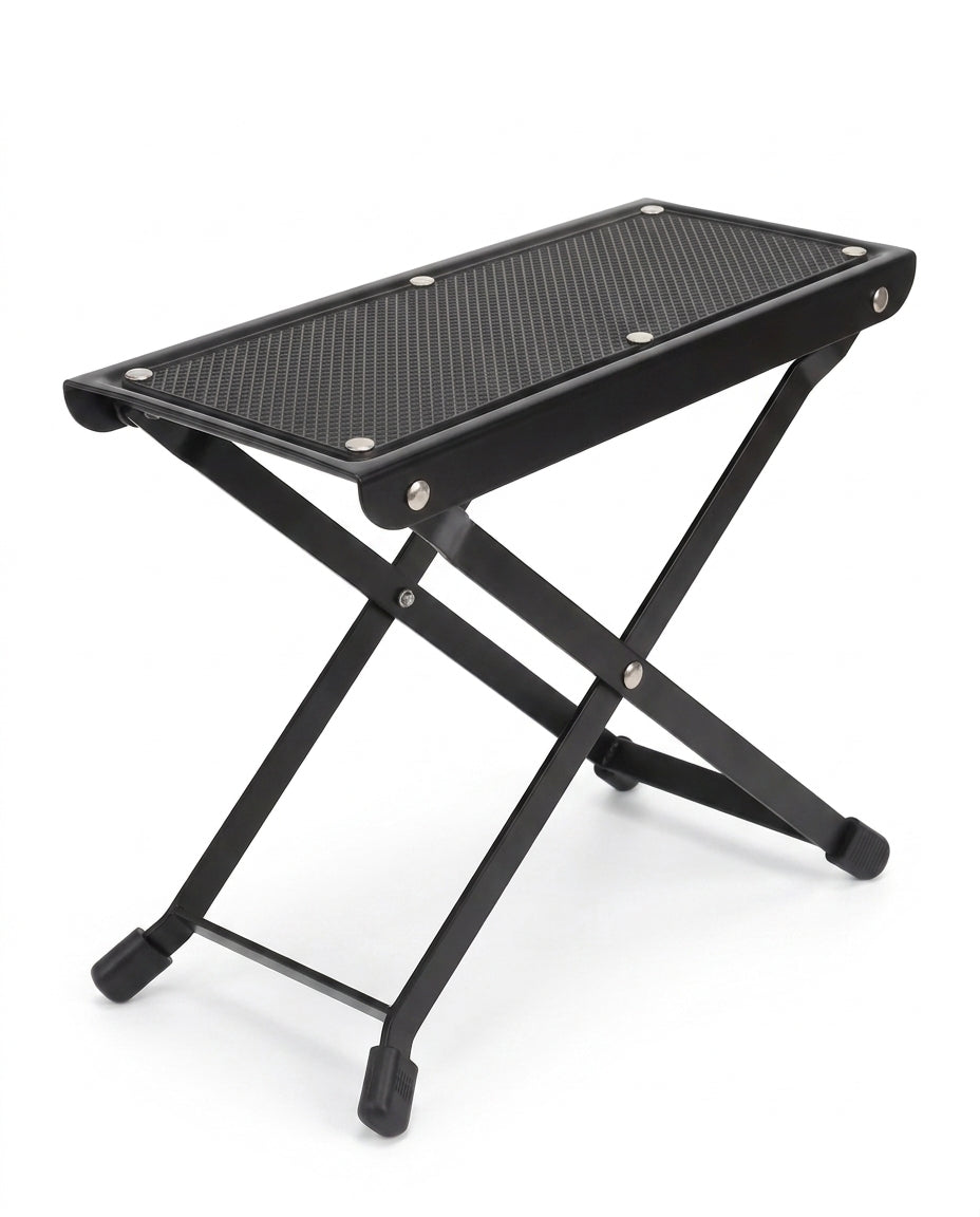 Black folding footrest platform with non-slip top and X-frame legs, on white