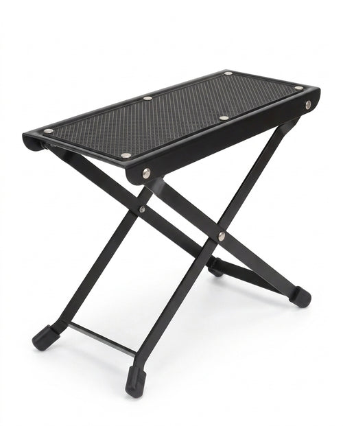 Black folding footrest platform with non-slip top and X-frame legs, on white