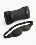 Black travel rest set with strapped neck pillow and contoured eye mask on white