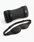 Black travel rest set with strapped neck pillow and contoured eye mask on white