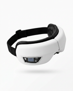 White eye massager with adjustable black strap and control panel, studio shot