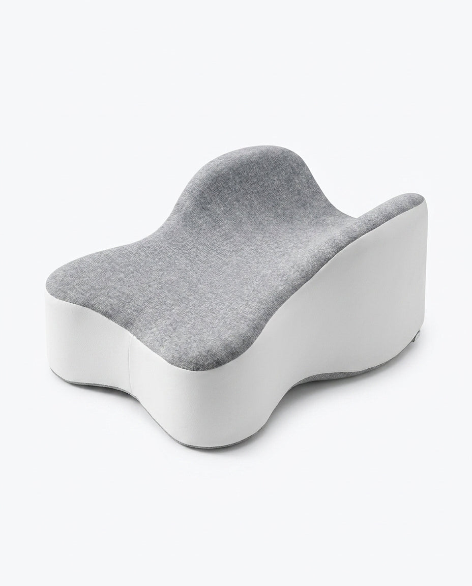 Grey contoured memory foam knee pillow with hourglass shape on white
