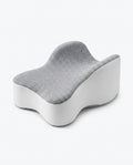 Grey contoured memory foam knee pillow with hourglass shape on white