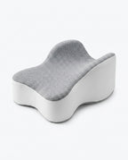 Grey contoured memory foam knee pillow with hourglass shape on white