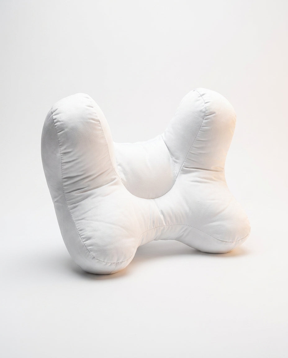 White butterfly-shaped ergonomic support pillow with central cradle, studio on white