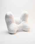 White butterfly-shaped ergonomic support pillow with central cradle, studio on white