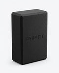 Black EVA foam yoga block with embossed Pyre Fit logo, studio shot on white