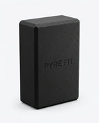 Black EVA foam yoga block with embossed Pyre Fit logo, studio shot on white