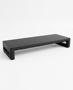 Black ergonomic monitor stand riser for desk, studio shot on white