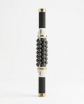 Electric rolling massage stick with black balls and gold caps on white