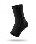 Black cooling compression ankle sleeve with gel pocket, studio shot on white