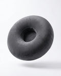 Grey velvet ring-shaped lap support pillow floating, studio shot on white