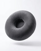 Grey velvet ring-shaped lap support pillow floating, studio shot on white