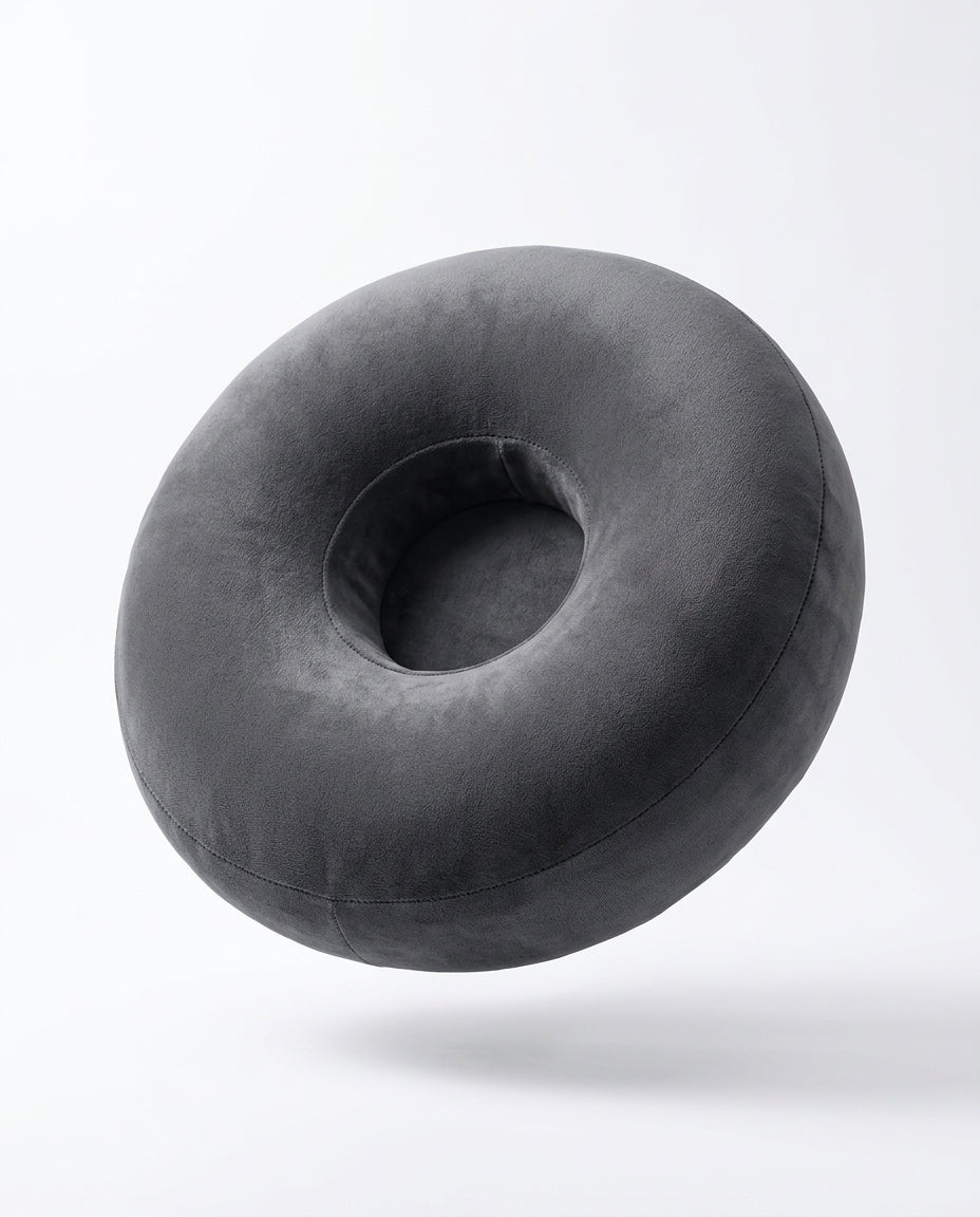 Grey velvet ring-shaped lap support pillow floating, studio shot on white