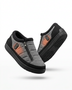Grey rechargeable heated house slippers with side zippers, studio packshot