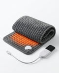 Grey rolled electric heating pad with glowing interior and LCD controller
