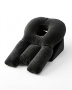 Black face-down support pillow with center face cradle and arm bolsters, studio shot