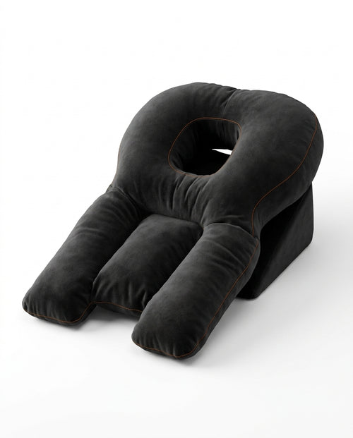 Black face-down support pillow with center face cradle and arm bolsters, studio shot