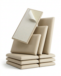 Stack of beige upholstered wall panels with peel-and-stick adhesive backing exposed