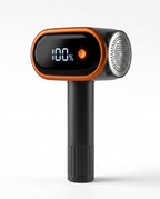 Black and orange portable fabric shaver with LCD battery display, studio shot
