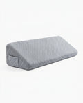 Grey quilted memory foam bed wedge gap filler pillow, studio shot on white