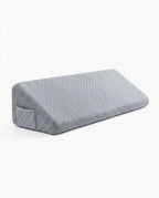 Grey quilted memory foam bed wedge gap filler pillow, studio shot on white
