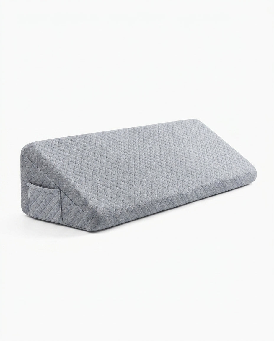 Grey quilted memory foam bed wedge gap filler pillow, studio shot on white