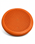 Orange inflatable balance disc with massage nubs, studio shot on white