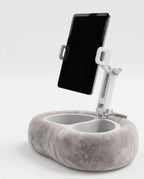 Grey velvet tablet pillow stand with adjustable arm holding a tablet, studio shot