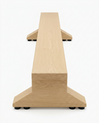 Wooden balance trainer beam on a pedestal base, end-on studio view on white