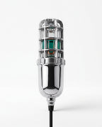 Chrome electric shoe dryer with caged UV head and green glow, on white