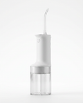 White cordless water flosser with clear tank and curved nozzle on white