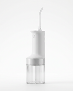 White cordless water flosser with clear tank and curved nozzle on white