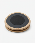 Round wooden rotational balance board with black textured top, studio shot on white