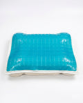 Blue gel grid cooling pillow cover over a quilted base, studio shot on white
