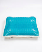 Blue gel grid cooling pillow cover over a quilted base, studio shot on white