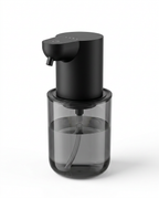 Black touchless foam soap dispenser with smoked clear reservoir, on white