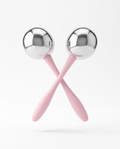 Two stainless steel cooling face rollers with pink handles crossed on white