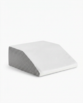 White and grey memory foam leg elevation wedge pillow on a white background
